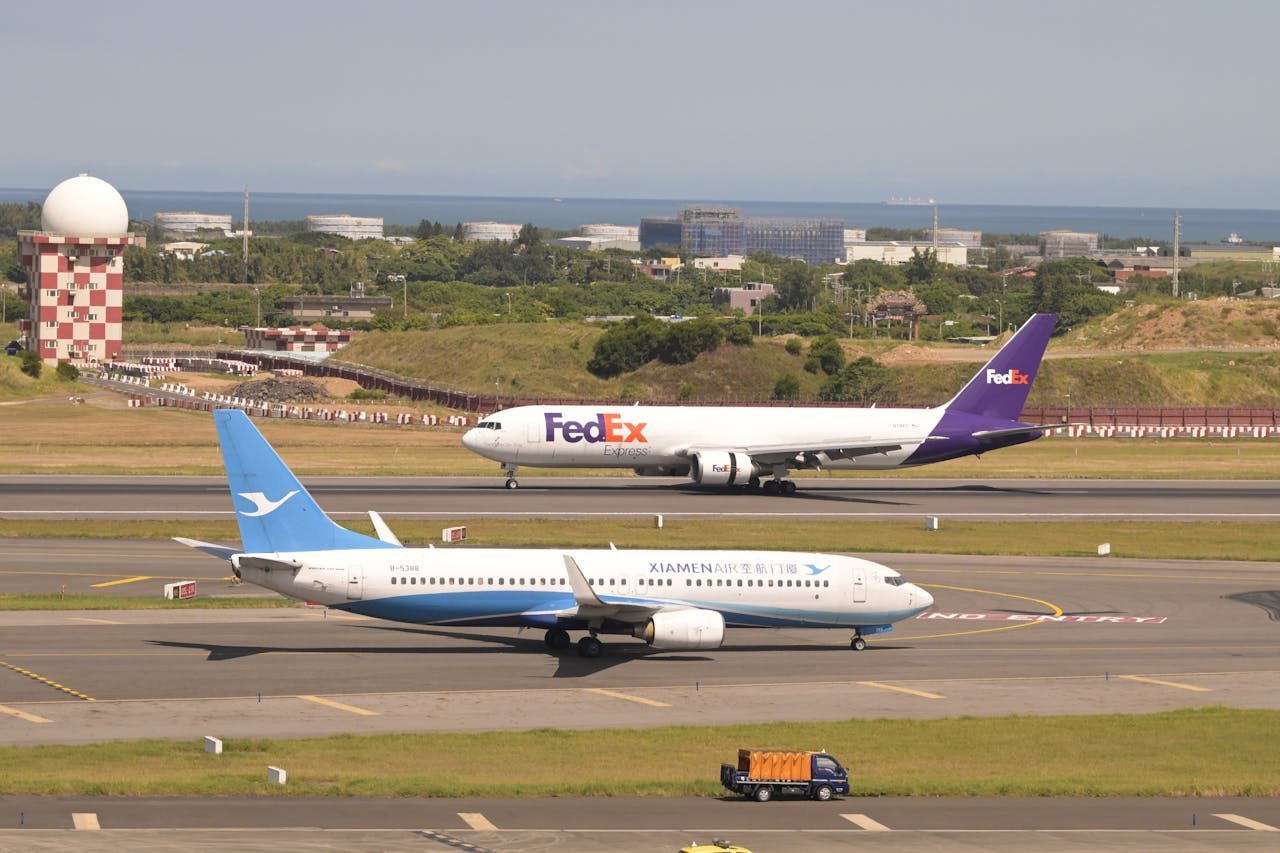FedEx and Xiamen Air planes on runway at Taoyuan International Airport in Taiwan.